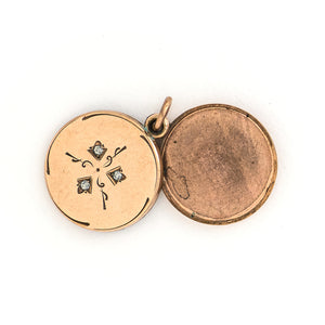 This simple round slide locket features 3 white glass stones and a minimalist thirds design. It slides opens to hold two photos and pairs perfectly with one of our antique gold fill chains.  Shown slid open