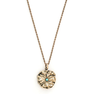 This incredible round locket features a sculpted pansy with a turquoise stone at its center. It is sterling silver with a gold wash and the textured petals catch the light at every turn. It opens to hold two photos and pairs perfectly with one of our antique sterling silver or gold fill chains. Front locket view, shown on chain