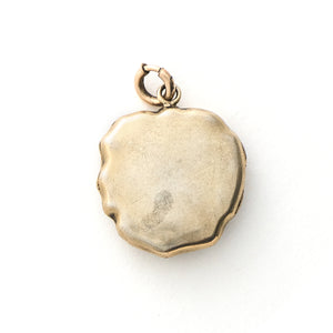 This incredible round locket features a sculpted pansy with a turquoise stone at its center. It is sterling silver with a gold wash and the textured petals catch the light at every turn. It opens to hold two photos and pairs perfectly with one of our antique sterling silver or gold fill chains. Back locket view