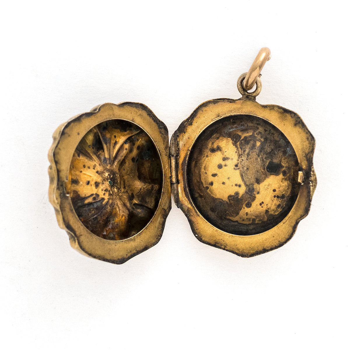 This incredible round locket features a sculpted pansy with a turquoise stone at its center. It is sterling silver with a gold wash and the textured petals catch the light at every turn. It opens to hold two photos and pairs perfectly with one of our antique sterling silver or gold fill chains. Open locket view