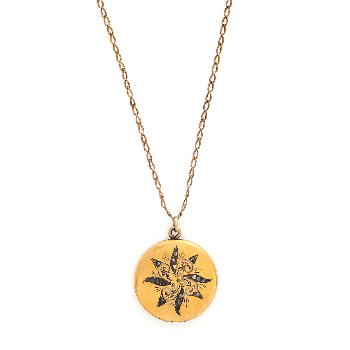 This matte round locket features a playful pinwheel design with white and grey glass stones scattered throughout. The initials CAI are inscribed on the back, it opens to hold two photos, includes both original frames and pairs perfectly with one of our antique gold fill chains. Front locket view, shown on chain