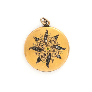 This matte round locket features a playful pinwheel design with white and grey glass stones scattered throughout. The initials CAI are inscribed on the back, it opens to hold two photos, includes both original frames and pairs perfectly with one of our antique gold fill chains. Front locket view