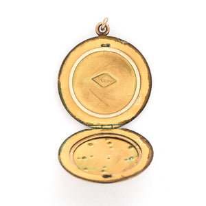 This matte round locket features a playful pinwheel design with white and grey glass stones scattered throughout. The initials CAI are inscribed on the back, it opens to hold two photos, includes both original frames and pairs perfectly with one of our antique gold fill chains. Open locket view