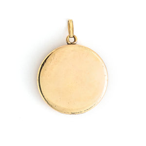 This round locket features a woman's profile in raised relief. Her head piece and necklace are adorned with white glass stones and compliment other intricate details such as her earrings and flowing long hair. It opens to hold two photos, includes one original frame and pairs perfectly with one of our antique gold fill chains. Back locket view
