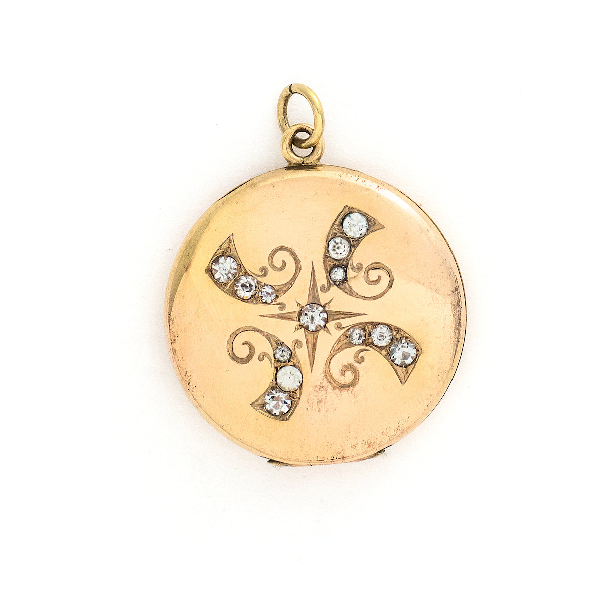 This radiant round locket features encrusted flourishes with the north star at its center. The initials MMP are inscribed on the back, it opens to hold two photos, includes both original frames and pairs perfectly with one of our antique gold fill chains.  Front locket view
