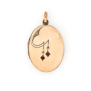 This oval locket features a simple Art Deco design with two red floral vines hanging down the center. It opens to hold two photos, includes both original frames and pairs perfectly with one of our antique gold fill chains. Front locket view