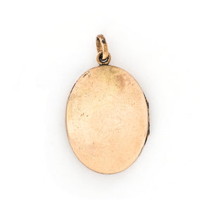 This oval locket features a simple Art Deco design with two red floral vines hanging down the center. It opens to hold two photos, includes both original frames and pairs perfectly with one of our antique gold fill chains. Back locket view