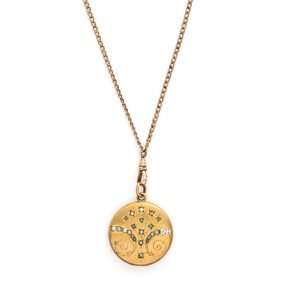 This matte round locket features 23 white glass stones scattered throughout a whimsical pattern of starbursts and ornamental swirls. It opens to hold one photo, includes the original frame and pairs perfectly with one of our antique gold fill chains.  Front locket view, shown on chain