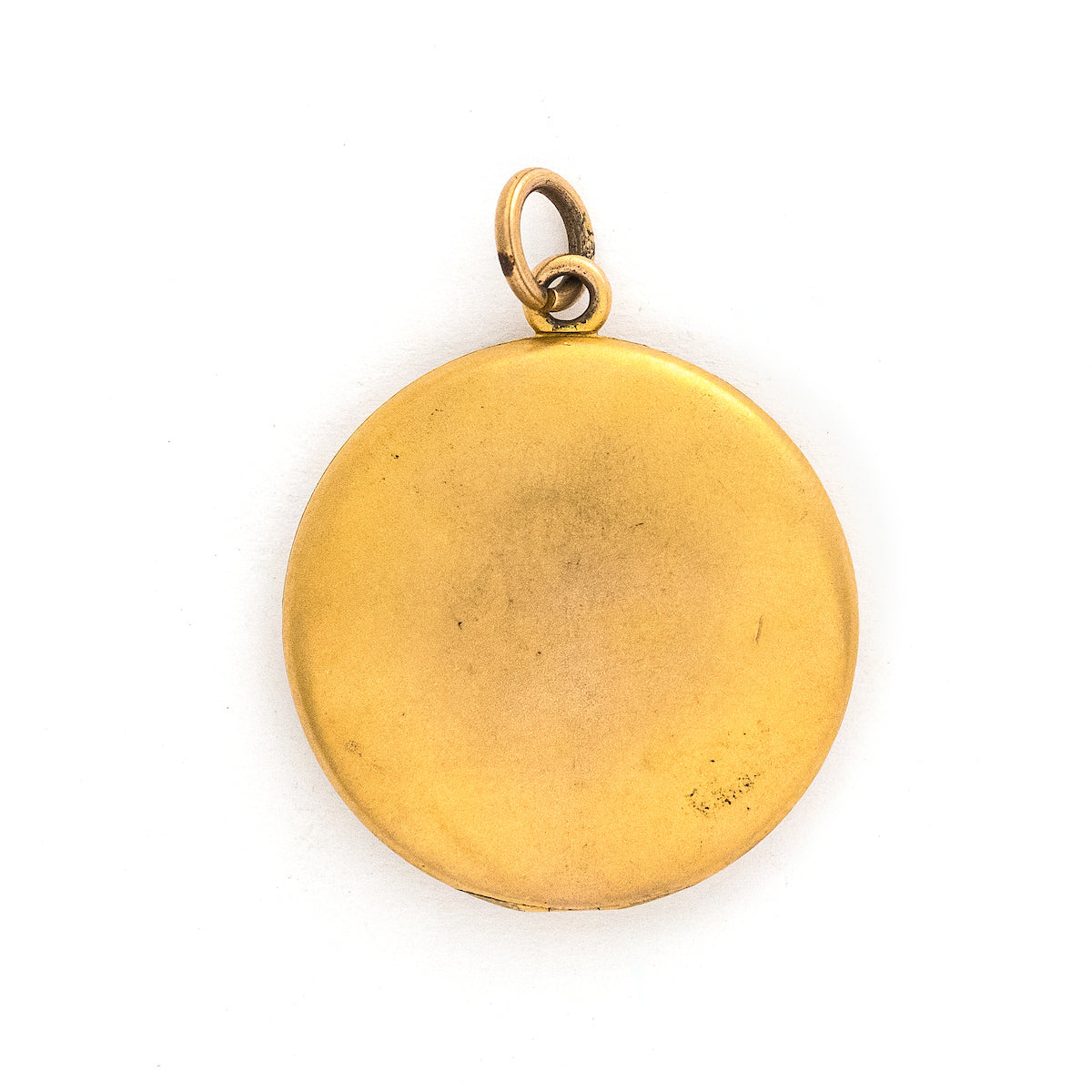 This matte round locket features 23 white glass stones scattered throughout a whimsical pattern of starbursts and ornamental swirls. It opens to hold one photo, includes the original frame and pairs perfectly with one of our antique gold fill chains.  Back locket view