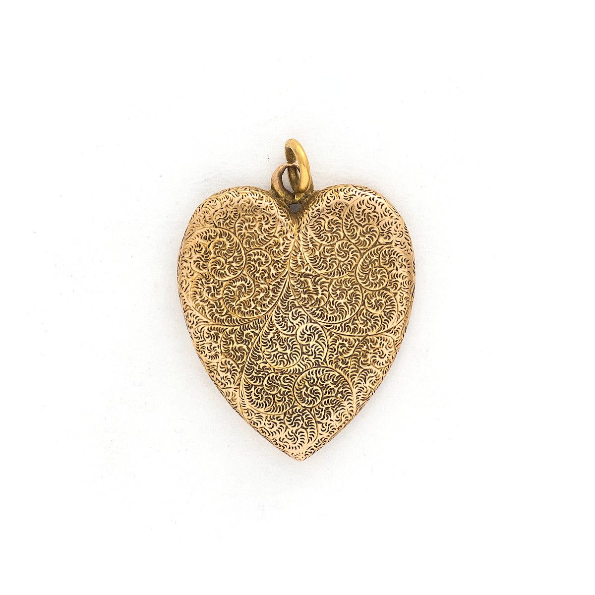 This heart shaped 14K gold locket features an earthy design reminiscent of tree roots with floral accents across the entire front and back of the locket. It opens to hold two photos, includes both original frames and pairs perfectly with one of our antique gold chains. Front locket view