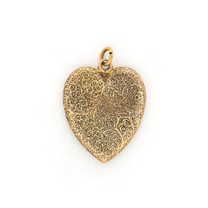 This heart shaped 14K gold locket features an earthy design reminiscent of tree roots with floral accents across the entire front and back of the locket. It opens to hold two photos, includes both original frames and pairs perfectly with one of our antique gold chains. Back locket view