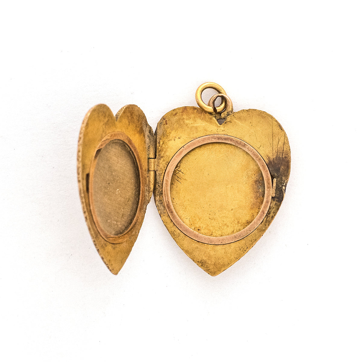This heart shaped 14K gold locket features an earthy design reminiscent of tree roots with floral accents across the entire front and back of the locket. It opens to hold two photos, includes both original frames and pairs perfectly with one of our antique gold chains. Open locket view