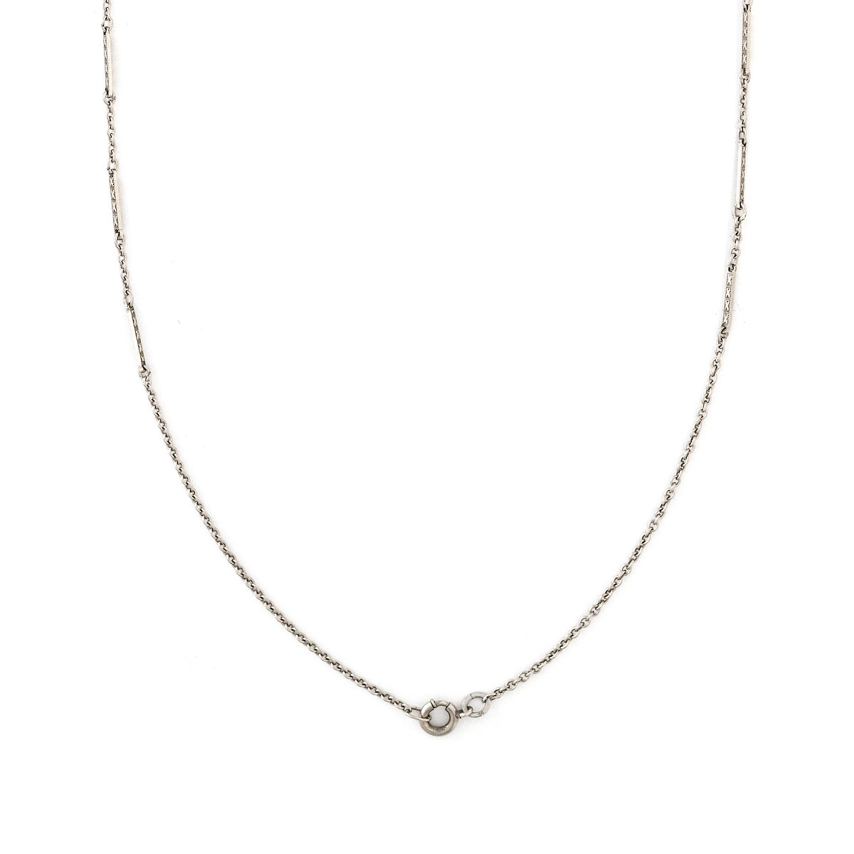 This dainty sterling silver vintage bar link watch chain features silver bars that are beautifully adorned with Xs on the front and back of each bar link. At 24", it pairs perfectly with one of our antique sterling silver or niello lockets, or worn on its own. Close up view, showing clasp