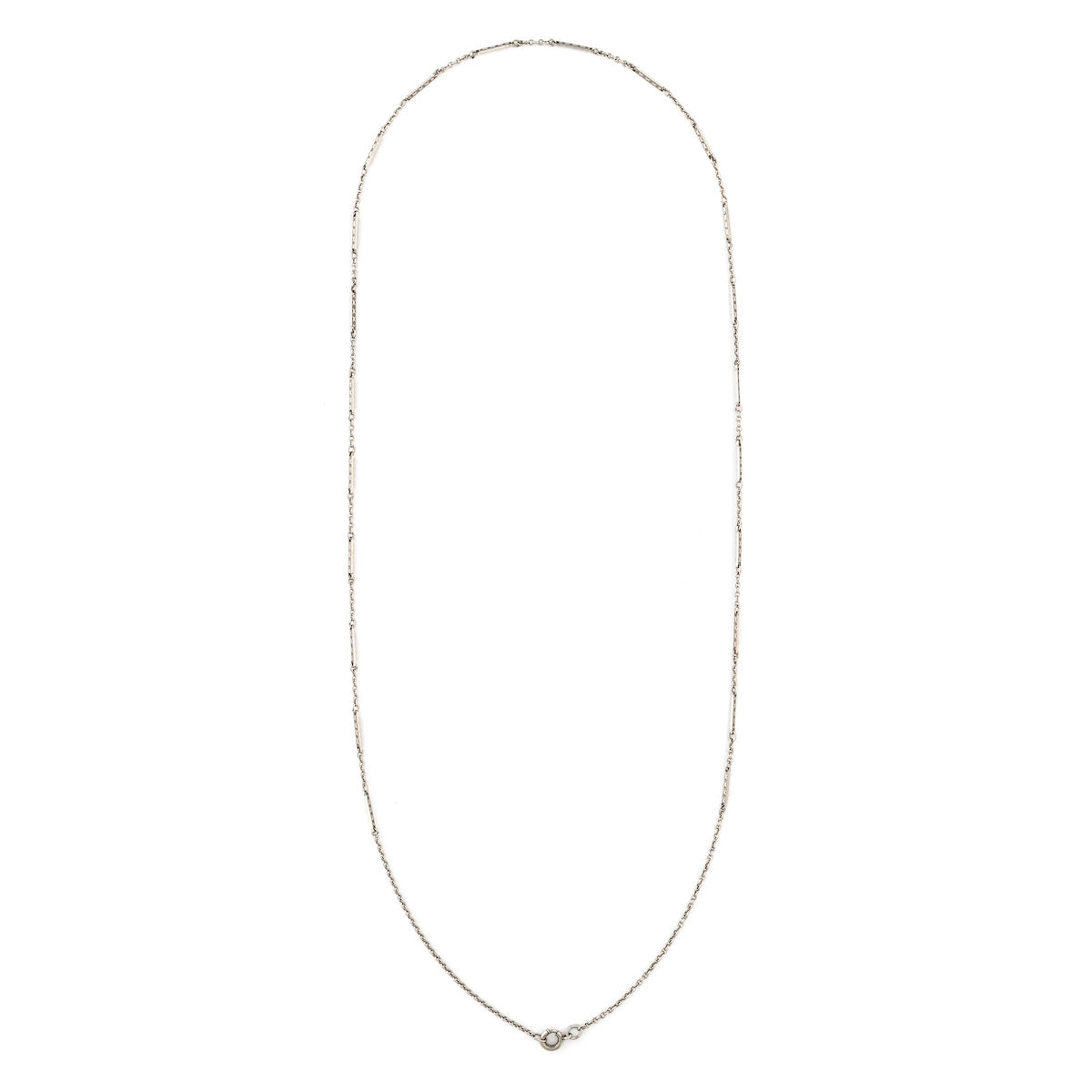This dainty sterling silver vintage bar link watch chain features silver bars that are beautifully adorned with Xs on the front and back of each bar link. At 24", it pairs perfectly with one of our antique sterling silver or niello lockets, or worn on its own. Close up view, showing clasp