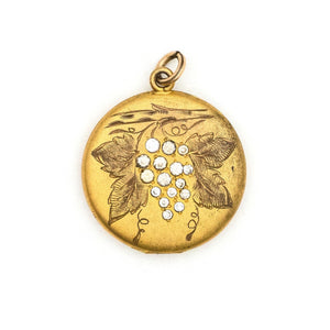 On the Vine Antique Locket, gold fill locket with grapes, leaves and a branch, with Victorian white paste stones, holds photos and pictures, front view