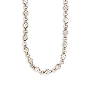 This Victorian-era chain is made of solid sterling silver and features intricately engraved horizontal diamond shapes interspersed with flat circular rings. Paired with a silver or silver and gold locket, this chain instantly makes a necklace more bold and eye-catching.  Close up view showing links