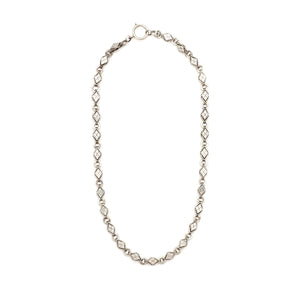 This Victorian-era chain is made of solid sterling silver and features intricately engraved horizontal diamond shapes interspersed with flat circular rings. Paired with a silver or silver and gold locket, this chain instantly makes a necklace more bold and eye-catching.  Full chain view